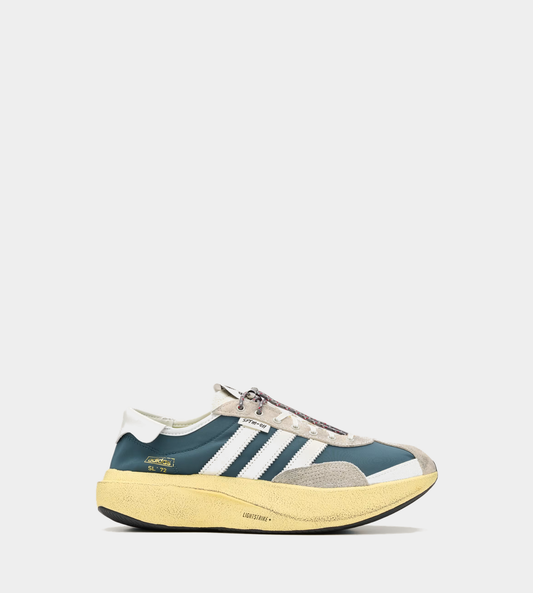Song for the Mute x adidas 008 SL72 Pro sneakers in Retro Blue, side view with white 3-Stripes and a yellow midsole